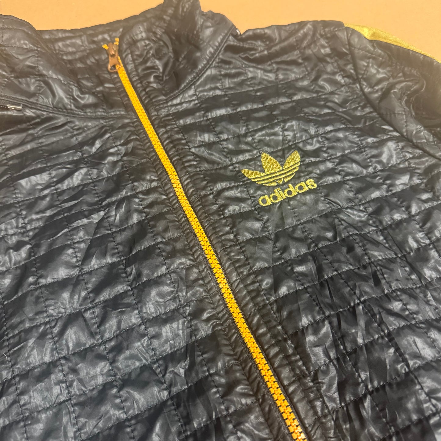 Adidas y2k-style black and golden rainjacket